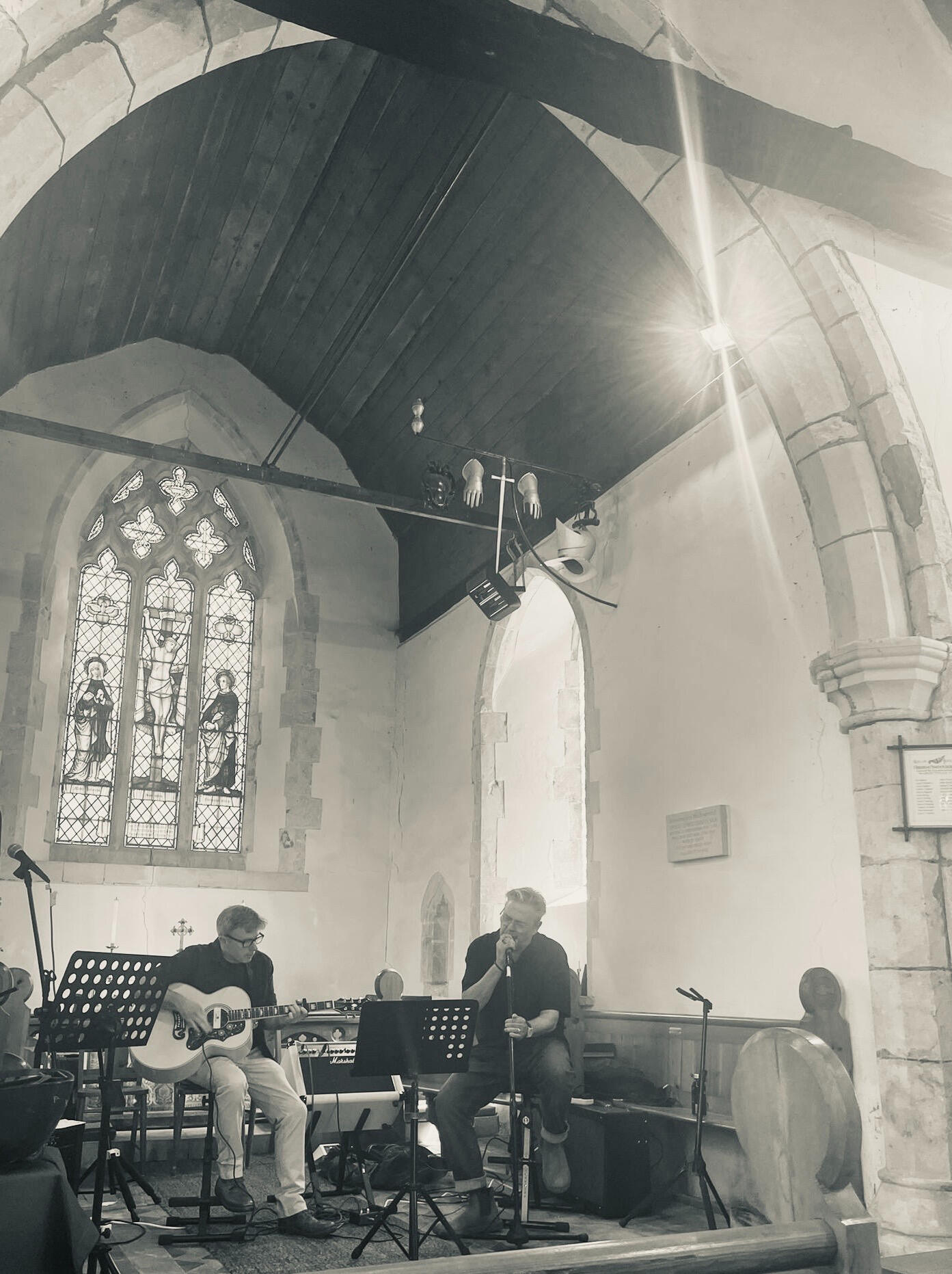 The Lost Afternoons playing at Shadoxhurst Midsummer Festival, 2024. David is on the left playing acoustic guitar, Peter is on the right, singing.